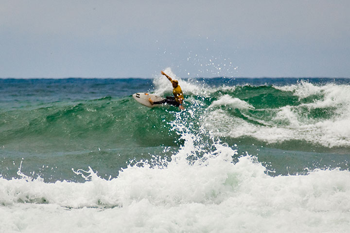 A surfer riding a wave at Swami's SMCA